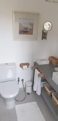 a bathroom with a white toilet and a sink at T3 Townhouse Old Village Vilamoura in Vilamoura