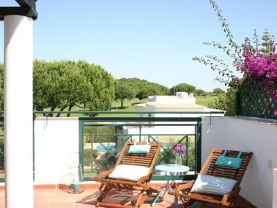 two chairs and a table on a patio at T3 Townhouse Old Village Vilamoura in Vilamoura