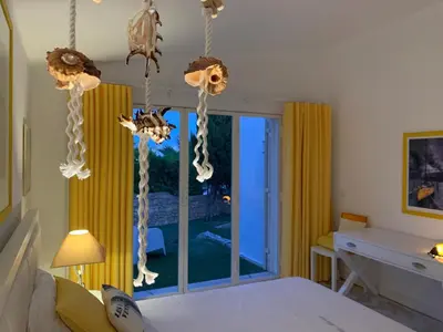 a bedroom with a bed and a desk and a window at Vila Marine in Albufeira