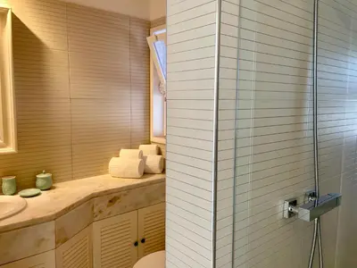 a bathroom with a shower and a sink at Vila Marine in Albufeira
