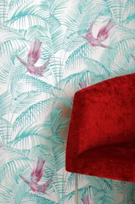a red hat sitting next to a wall with a wallpaper at L&F House in Algoz