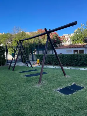 an empty swing set in a park at Belavista Apartment in Albufeira