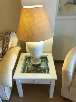 a lamp on a table next to two chairs at Palm Garden in Vilamoura