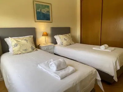 two beds sitting next to each other in a room at Palm Garden in Vilamoura