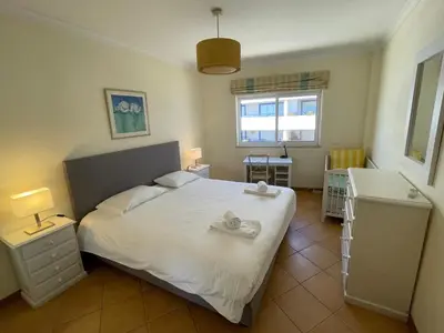 a bedroom with a white bed and a window at Palm Garden in Vilamoura