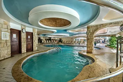 a pool in a hotel room with a large swimming pool at Four Seasons Country Club in Quinta do Lago