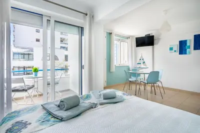 a bedroom with a large bed with two pillows on it at Apartamento Mar in Quarteira