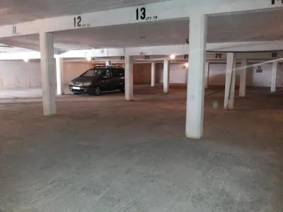 a parking garage with a car parked in it at Regueiró Quarteira Beach Apartment in Quarteira