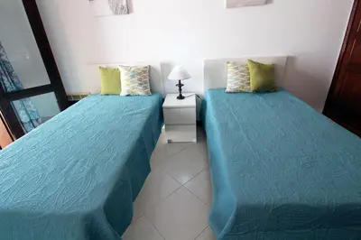 two beds sitting next to each other in a bedroom at Vilamouratenis 'Blue' by SAPvillas in Vilamoura