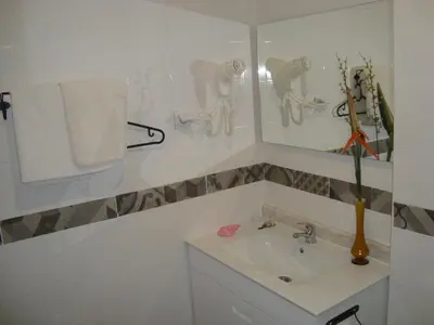 a white bathroom with a sink and a mirror at Vila Algarvia Boutique & Suites in Albufeira