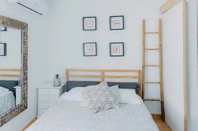 a bedroom with a bed and a mirror at Home Santa Clara in Albufeira