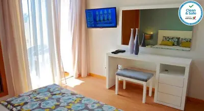 a bedroom with a desk with a chair and a mirror at House F São Rafael Beach - Free Wifi & Airco, NETFLIX ready - 300m from the beach in Albufeira