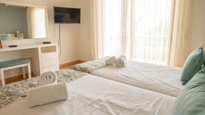a hotel room with a bed and a window at House F São Rafael Beach - Free Wifi & Airco, NETFLIX ready - 300m from the beach in Albufeira