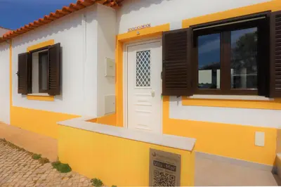 a yellow and white house with a door and windows at Vila - Mar - Private outdoor Jacuzzi - wifi & airco - by bedzy in Albufeira