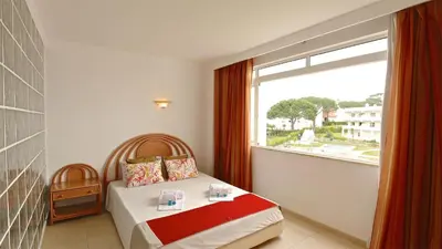 a bedroom with a bed and a large window at Terraços do Mar 46- Clever Details in Vilamoura