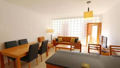 a living room with a table and chairs and a couch at Terraços do Mar 46- Clever Details in Vilamoura