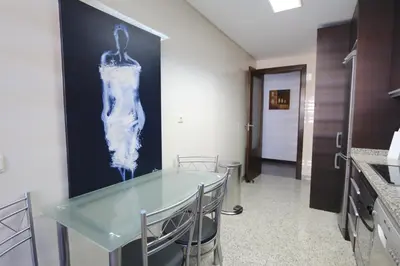 a dining room with a glass table in a kitchen at Monte Laguna - Clever Details in Vilamoura