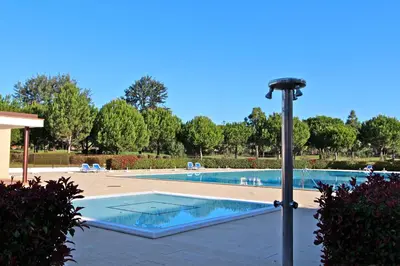 a light pole next to a swimming pool at Monte Laguna - Clever Details in Vilamoura