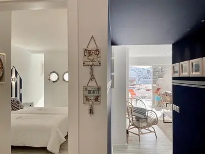 a bedroom with a bed and a view of a balcony at Ocean Balcony apartment terrace sea view and pool in Albufeira