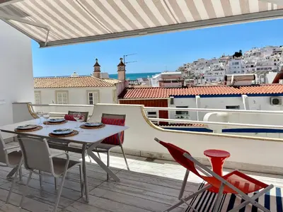 a table and chairs on a balcony with a view at Ocean Balcony apartment terrace sea view and pool in Albufeira