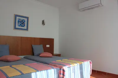 a bedroom with two beds at Apartamentos Colina do Mar Downtown Albufeira in Albufeira