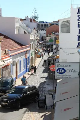 a car parked on a street in a town at Apartamentos Colina do Mar Downtown Albufeira in Albufeira
