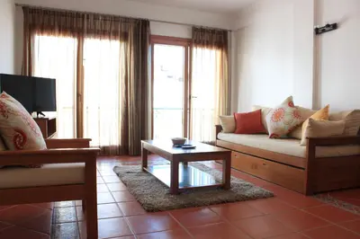 a living room with a couch and a coffee table at Apartamentos Colina do Mar Downtown Albufeira in Albufeira