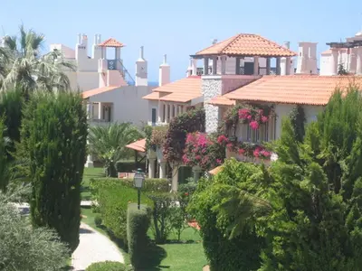 a house with a garden with flowers and trees at Old Village in Vilamoura