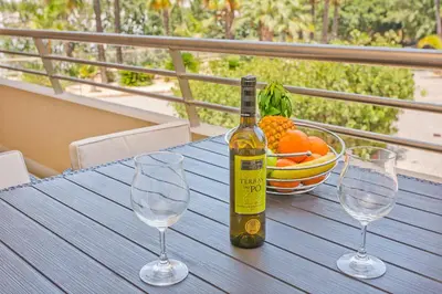 a bottle of wine sitting on a table with two wine glasses at Apartamento em Quinta da Barracuda in Albufeira