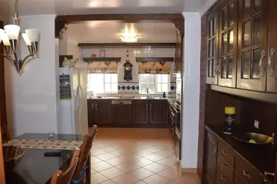 a kitchen with a table and a dining room at Casa das Figuras in Faro