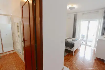 a room with a door and a room with a table at Pinhal do Golf - Clever Details in Vilamoura