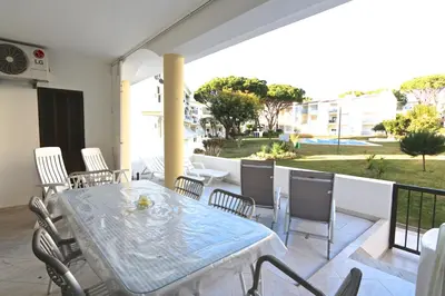 a patio with a table and chairs on a balcony at Pinhal do Golf - Clever Details in Vilamoura