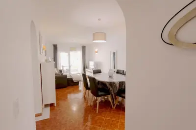 a kitchen and dining room with a table and chairs at Pinhal do Golf - Clever Details in Vilamoura