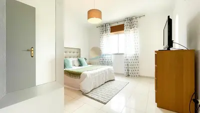 a bedroom with a bed and a television in it at Vila Ricardo by Sunny Deluxe in Albufeira
