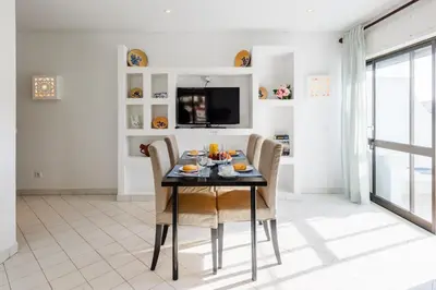 a dining room with a table and chairs at Casas Barulho Apartments Old Town in Albufeira