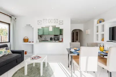 a living room with a couch and a table at Casas Barulho Apartments Old Town in Albufeira
