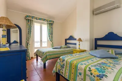 a bedroom with two beds and a window at Marina de Vilamoura Apart in Vilamoura