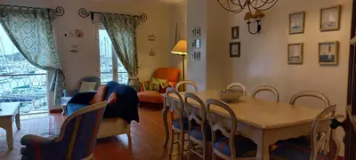 a living room with a table and chairs at Marina de Vilamoura Apart in Vilamoura