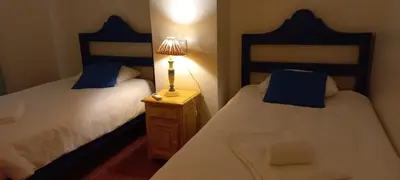 a bedroom with two beds and a lamp on a night stand at Marina de Vilamoura Apart in Vilamoura