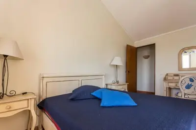 a bedroom with a blue bed and a desk at Marina de Vilamoura Apart in Vilamoura
