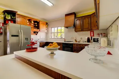a kitchen with a counter with a bowl of fruit on it at Villas2go2 V5 Vilamoura XXI in Vilamoura