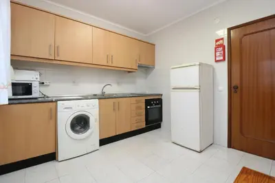 a kitchen with a washing machine and a refrigerator at Villa Lena in Albufeira