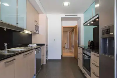 a large kitchen with a sink and a stove at Marina Vilamoura Penthouse Aquamar 606 in Vilamoura