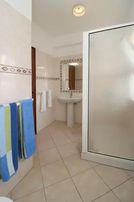 a bathroom with a shower and a sink at Villa Gonçalves in Albufeira