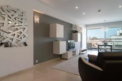 a living room with a couch and a television at Aquamar 416 by Vilamoura Sun - espaçoso, in Vilamoura