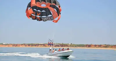 a group of people on a boat in the water with a parachute at Aquamar 416 by Vilamoura Sun - espaçoso, in Vilamoura