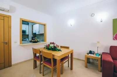 a kitchen with a bowl of fruit on a counter at Grand Muthu Forte do Vale in Albufeira