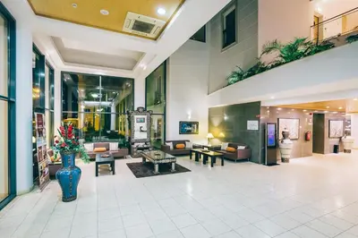 a lobby with couches and tables and plants at Grand Muthu Forte do Vale in Albufeira