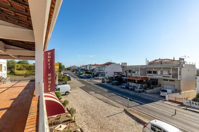 a view of a city street from a balcony at Guest House Oliveira in Boliqueime