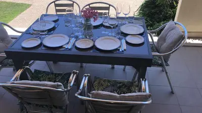 a blue table with plates and wine glasses on it at Marina Vilamoura - Aquamar 012 - by VilamouraSun in Vilamoura